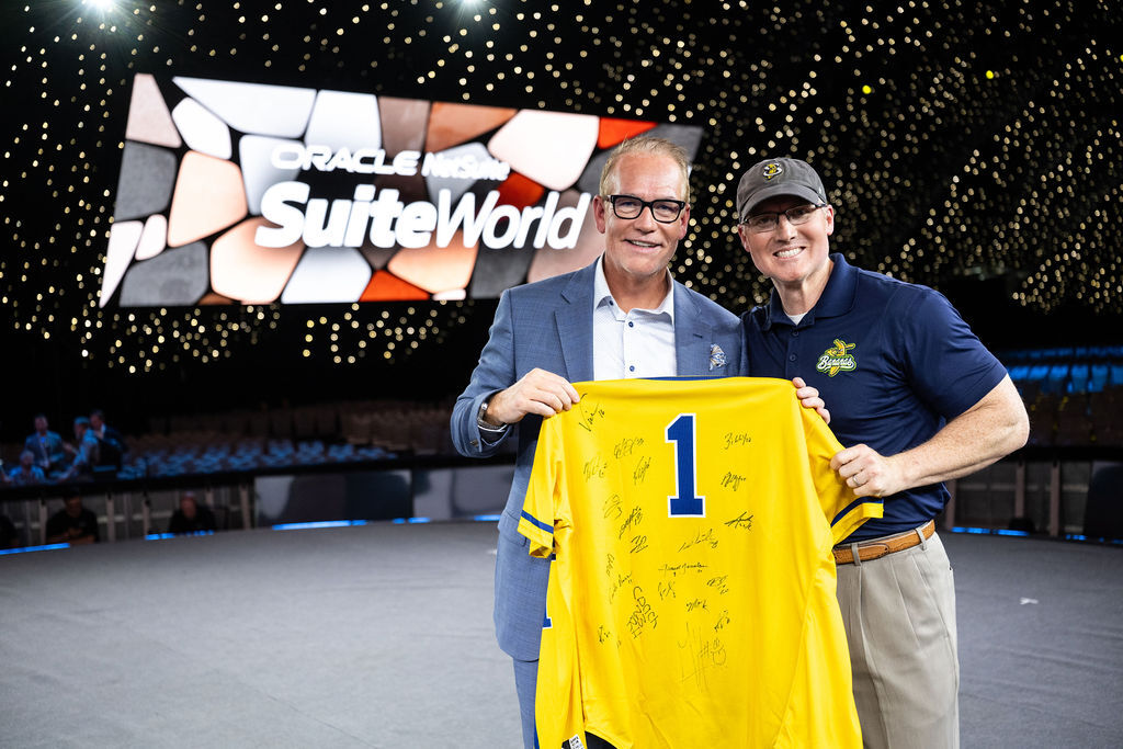 Tim Naddy presenting a signed Savannah Bananas jersey on the SuiteWorld stage